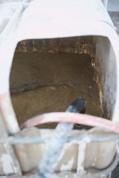 A view inside a concrete waste water container and how to remove the solids from the water.